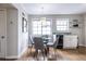 Bright dining area features hardwood floors, round glass table, and stylish pendant lighting at 410 Candler Park Ne Dr # C-1, Atlanta, GA 30307