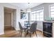 Cozy dining area with hardwood floors, a glass table, and a view of the kitchen and hallway at 410 Candler Park Ne Dr # C-1, Atlanta, GA 30307