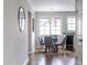 Cozy dining area featuring a modern chandelier and natural light from a large window at 410 Candler Park Ne Dr # C-1, Atlanta, GA 30307