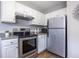 Contemporary kitchen featuring white cabinets, stainless steel appliances, and hardwood floors at 410 Candler Park Ne Dr # C-1, Atlanta, GA 30307