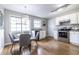 Well-lit kitchen with modern stainless steel appliances, white cabinetry, and a cozy dining area at 410 Candler Park Ne Dr # C-1, Atlanta, GA 30307