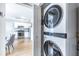 Bright laundry area with a stacked washer and dryer at 410 Candler Park Ne Dr # C-1, Atlanta, GA 30307