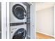 This laundry room has a stacked washer and dryer with built in storage at 410 Candler Park Ne Dr # C-1, Atlanta, GA 30307