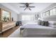 Bright main bedroom with a large bed, natural light, and hardwood floors at 410 Candler Park Ne Dr # C-1, Atlanta, GA 30307