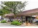 Exterior view of Candler Park Market, showing the building, outdoor seating and bike at 410 Candler Park Ne Dr # C-1, Atlanta, GA 30307