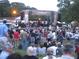 Outdoor concert with a large crowd enjoying a live musical performance on stage at 410 Candler Park Ne Dr # C-1, Atlanta, GA 30307