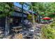 Outdoor dining area with tables and chairs, surrounded by lush greenery at 410 Candler Park Ne Dr # C-1, Atlanta, GA 30307