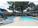 Community pool with lounge chairs for relaxation at 410 Candler Park Ne Dr # C-1, Atlanta, GA 30307