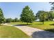 Expansive grassy yard with mature trees and a winding driveway on a sunny day at 410 Candler Park Ne Dr # C-1, Atlanta, GA 30307