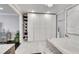 Bathroom featuring a large closet, marble floor, white tub, and stylish decor at 54 Basswood Cir, Atlanta, GA 30328