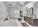 Bathroom features a large tub with a tile surround and a vanity with dual sinks at 54 Basswood Cir, Atlanta, GA 30328