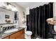 Bathroom with a granite countertop, dark cabinets, modern sink and vanity, and a shower at 54 Basswood Cir, Atlanta, GA 30328