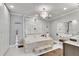 Luxurious bathroom features a soaking tub with stone accents and a modern chandelier at 54 Basswood Cir, Atlanta, GA 30328