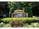 Community sign reading Dunwoody Springs with stone and manicured landscaping at 54 Basswood Cir, Atlanta, GA 30328