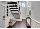 Bright foyer with dark wood floors, detailed trim, and staircase leading up to a sunny window at 54 Basswood Cir, Atlanta, GA 30328