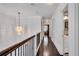 Upstairs hallway with hardwood floors, chandelier, and access to bedrooms at 54 Basswood Cir, Atlanta, GA 30328