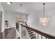 Upstairs hallway features hardwood floors, a chandelier, and views of the outdoors at 54 Basswood Cir, Atlanta, GA 30328