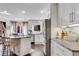 Modern kitchen featuring white cabinets, granite countertops, stainless steel appliances, and breakfast bar at 54 Basswood Cir, Atlanta, GA 30328