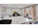 Spacious living area with white tile flooring, modern TV stand, and french doors to patio at 54 Basswood Cir, Atlanta, GA 30328