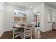 Cozy breakfast nook with a round wooden table, four chairs, and a view of the backyard through a bright window at 1611 Saddlegate Dr, Canton, GA 30114