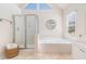 Spa-like bathroom featuring a soaking tub, walk-in shower, and large mirror at 179 Waterstone Pt, Acworth, GA 30101