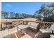 Relaxing deck with golf course view, wicker furniture, and grill at 179 Waterstone Pt, Acworth, GA 30101