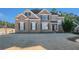 Two-story brick home with landscaping and driveway at 179 Waterstone Pt, Acworth, GA 30101