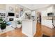 Open kitchen boasts hardwood floors, white cabinetry, and island at 179 Waterstone Pt, Acworth, GA 30101