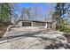 View of the house showing the long driveway, two-car garage and front porch at 693 Peyton Sw Rd, Atlanta, GA 30311