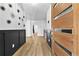 Inviting foyer featuring modern front door, stylish wood flooring and decorative wall accents at 693 Peyton Sw Rd, Atlanta, GA 30311