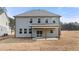 Two-story house with gray siding, covered patio, and fenced backyard at 11 Ramble Way, Sharpsburg, GA 30277