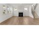 Bright living room with hardwood floors, fireplace, and staircase at 11 Ramble Way, Sharpsburg, GA 30277