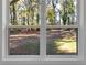 Window view shows backyard with trees and open area, enhancing the home's connection to nature at 2358 Tilson Rd, Decatur, GA 30032