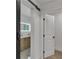 Modern bathroom featuring a sliding barn door and a marble-topped vanity with double sinks at 2358 Tilson Rd, Decatur, GA 30032