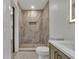 Modern bathroom features a marble shower, built-in niche, and neutral fixtures and finishes at 2358 Tilson Rd, Decatur, GA 30032