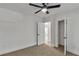 Cozy bedroom with neutral carpet, ceiling fan, and open doorway to a walk-in closet at 2358 Tilson Rd, Decatur, GA 30032