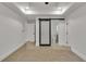 The bedroom with a sliding barn door leading to the bathroom features modern lighting and neutral decor at 2358 Tilson Rd, Decatur, GA 30032