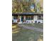 Inviting exterior of a home with white brick, fresh landscaping and an updated stained wood porch at 2358 Tilson Rd, Decatur, GA 30032