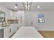 Beautiful kitchen with white cabinets, marble backsplash and countertops, modern lighting, and stainless appliances at 2358 Tilson Rd, Decatur, GA 30032