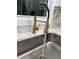 Close up of the modern kitchen sink with marble countertops and a coil faucet at 2358 Tilson Rd, Decatur, GA 30032