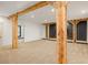 Basement featuring wooden beams, carpet flooring, and accent wall at 2731 Tribble Mill Rd, Lawrenceville, GA 30045