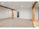 Unfinished basement with exposed wooden beams and carpeted floor at 2731 Tribble Mill Rd, Lawrenceville, GA 30045