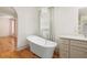 Elegant bathroom showcases a standalone tub, a large window, and views into a bedroom area at 2731 Tribble Mill Rd, Lawrenceville, GA 30045