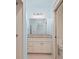 Bright bathroom vanity with granite countertop, decorative mirror, and traditional lighting at 2731 Tribble Mill Rd, Lawrenceville, GA 30045