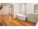 Elegant bathroom showcases a standalone tub, a large window, and views into a bedroom area at 2731 Tribble Mill Rd, Lawrenceville, GA 30045