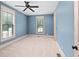 Spacious bedroom with light blue walls and carpeted floor at 2731 Tribble Mill Rd, Lawrenceville, GA 30045