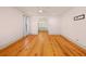 Spacious bedroom featuring hardwood floors, light walls, and a charming arched doorway leading to the bathroom at 2731 Tribble Mill Rd, Lawrenceville, GA 30045