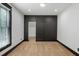 Bedroom with decorative wallpaper, neutral carpet, modern window and stylish sliding barn door at 2731 Tribble Mill Rd, Lawrenceville, GA 30045