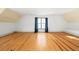 Bright bonus room featuring hardwood floors and a window with blue curtains at 2731 Tribble Mill Rd, Lawrenceville, GA 30045