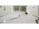 Large garage with shiny epoxy floors, glass garage doors, black sconces, and a four wheeler inside at 2731 Tribble Mill Rd, Lawrenceville, GA 30045